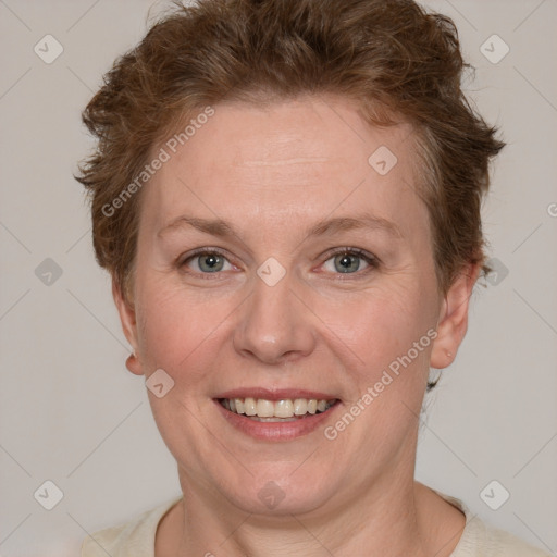 Joyful white adult female with short  brown hair and blue eyes