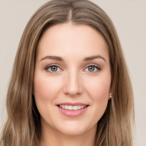 Joyful white young-adult female with long  brown hair and green eyes