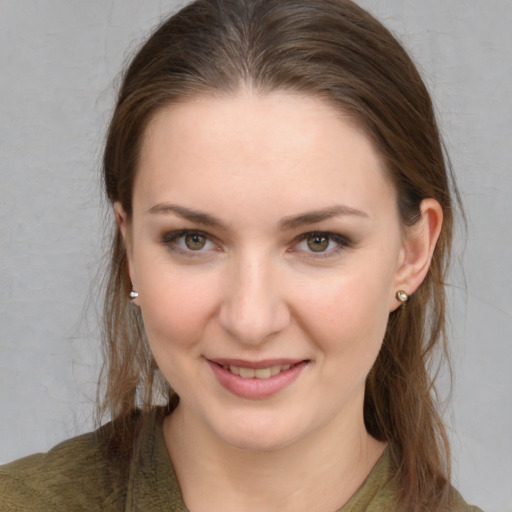 Joyful white young-adult female with medium  brown hair and grey eyes