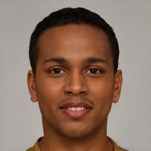Joyful black young-adult male with short  brown hair and brown eyes