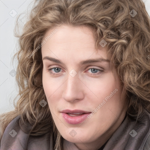 Joyful white young-adult female with long  brown hair and blue eyes