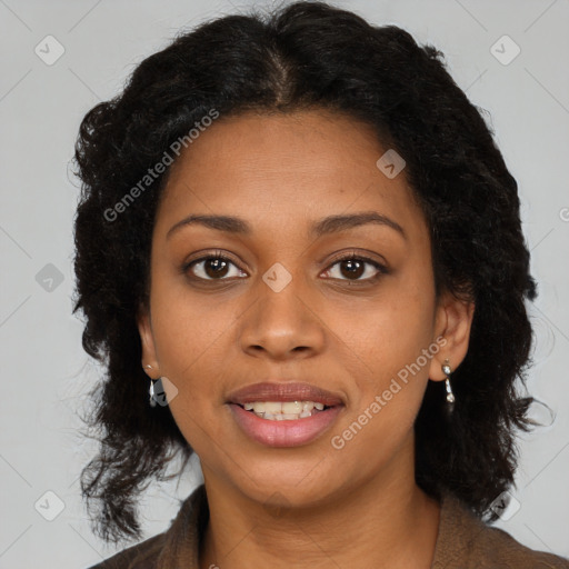 Joyful black young-adult female with long  brown hair and brown eyes