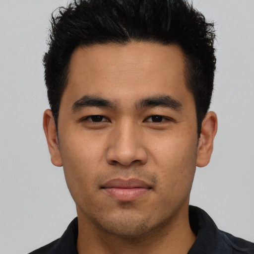 Joyful asian young-adult male with short  black hair and brown eyes