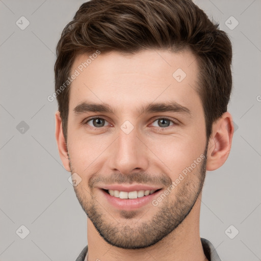 Joyful white young-adult male with short  brown hair and grey eyes