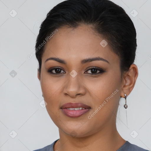 Joyful latino young-adult female with medium  brown hair and brown eyes