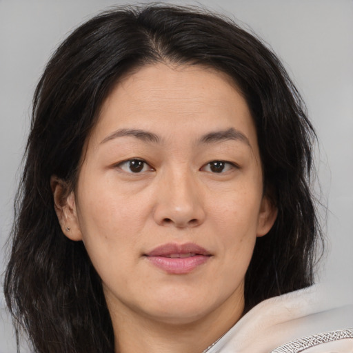 Joyful asian adult female with medium  brown hair and brown eyes