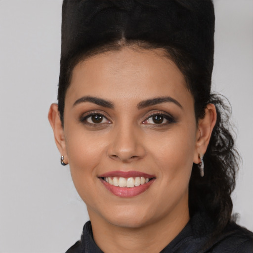 Joyful latino young-adult female with short  brown hair and brown eyes