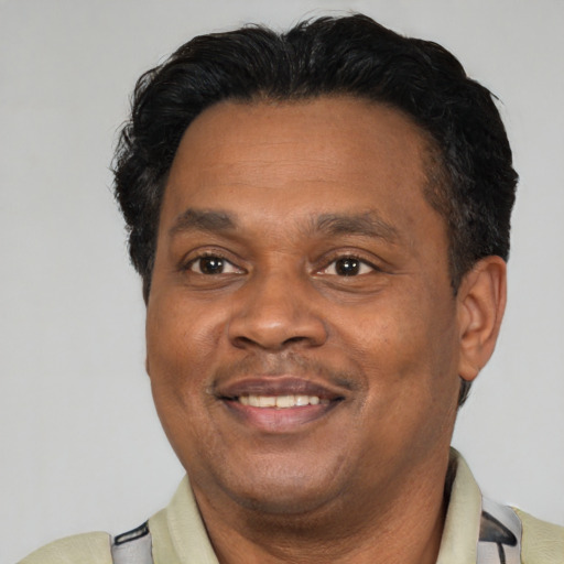 Joyful latino adult male with short  brown hair and brown eyes