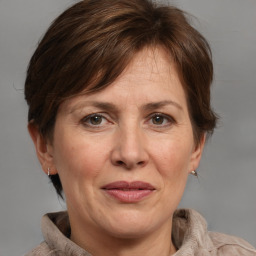 Joyful white adult female with medium  brown hair and grey eyes