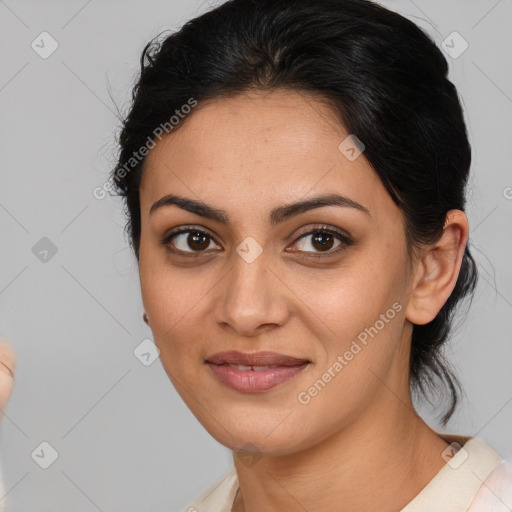 Joyful latino young-adult female with medium  brown hair and brown eyes