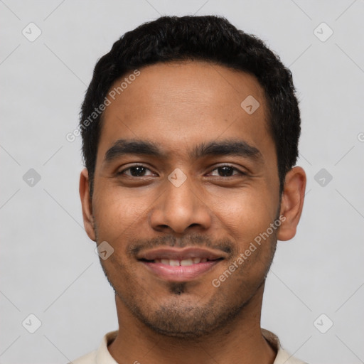 Joyful latino young-adult male with short  black hair and brown eyes