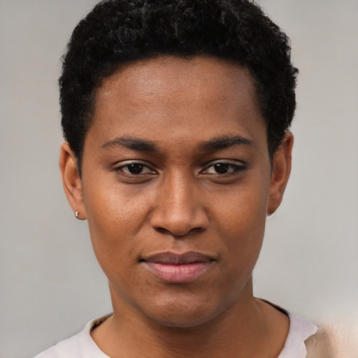 Joyful black young-adult female with short  black hair and brown eyes