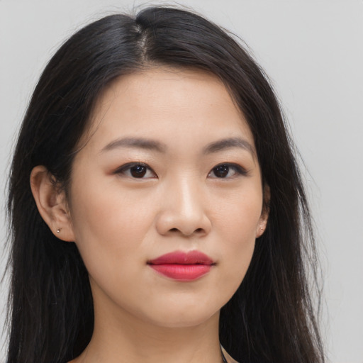 Joyful asian young-adult female with long  brown hair and brown eyes
