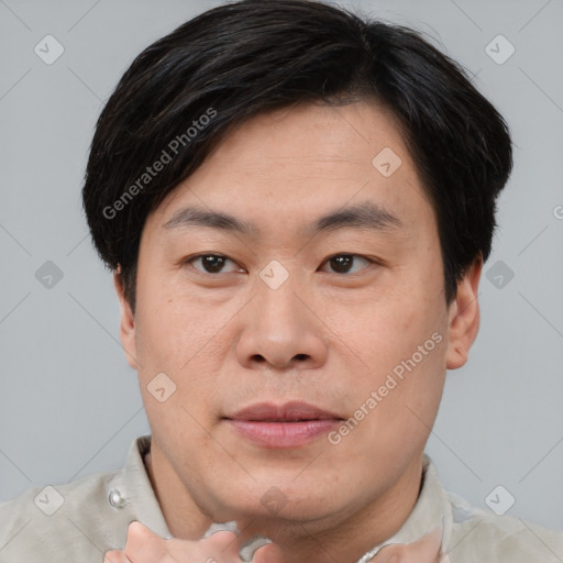 Joyful asian young-adult male with short  brown hair and brown eyes