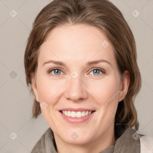 Joyful white adult female with medium  brown hair and grey eyes