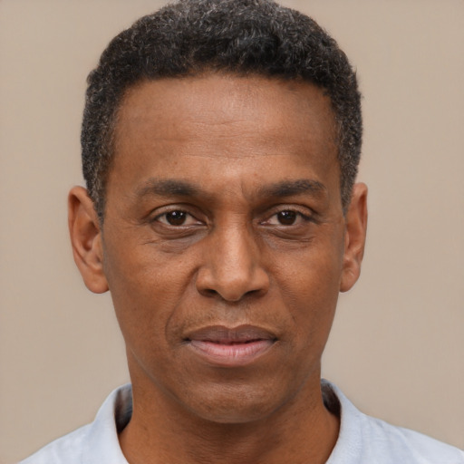 Joyful latino adult male with short  black hair and brown eyes