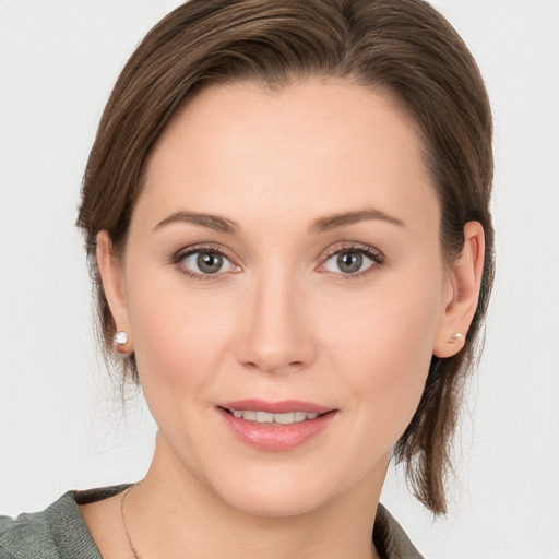 Joyful white young-adult female with medium  brown hair and blue eyes