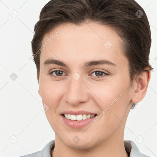 Joyful white young-adult female with short  brown hair and brown eyes