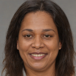 Joyful white adult female with long  brown hair and brown eyes