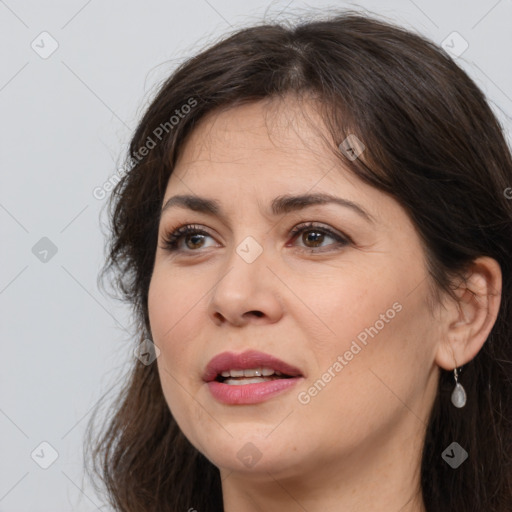 Joyful white adult female with long  brown hair and brown eyes