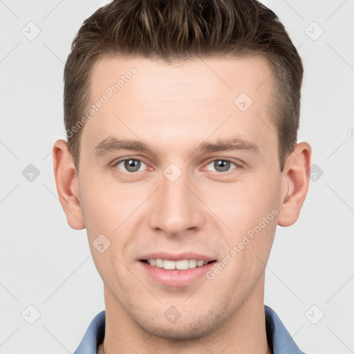 Joyful white young-adult male with short  brown hair and grey eyes