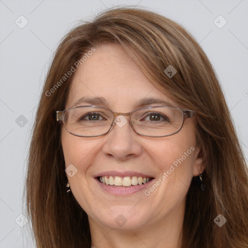 Joyful white adult female with long  brown hair and grey eyes