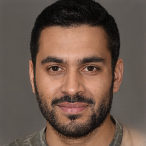 Joyful latino young-adult male with short  black hair and brown eyes