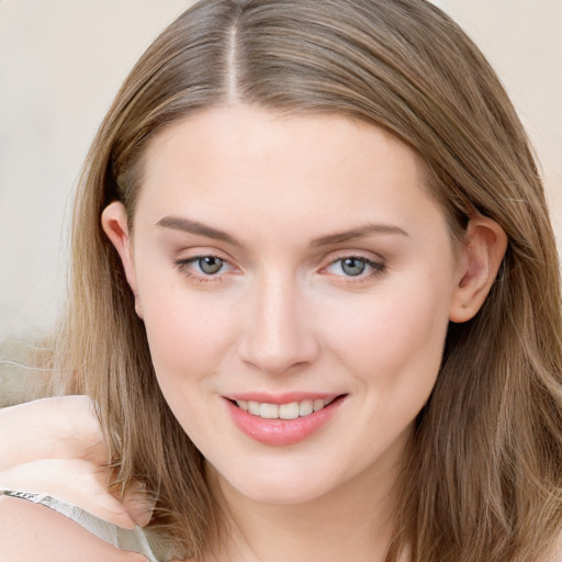 Joyful white young-adult female with long  brown hair and blue eyes