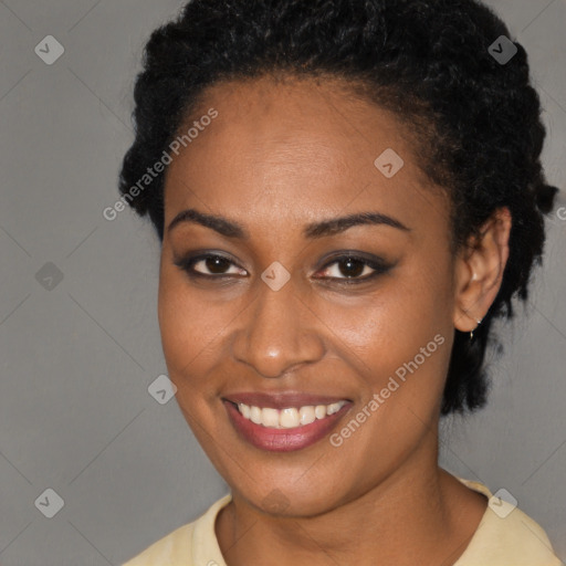 Joyful black young-adult female with short  black hair and brown eyes