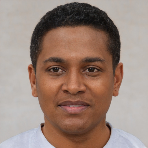 Joyful latino young-adult male with short  black hair and brown eyes