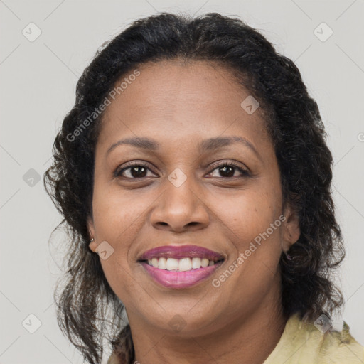 Joyful black adult female with medium  brown hair and brown eyes