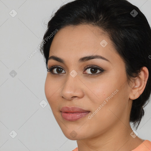 Joyful latino young-adult female with medium  brown hair and brown eyes