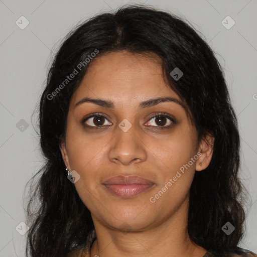 Joyful black young-adult female with long  brown hair and brown eyes