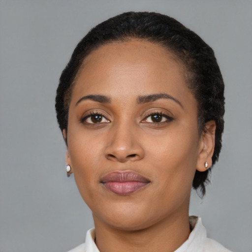 Joyful black young-adult female with short  black hair and brown eyes