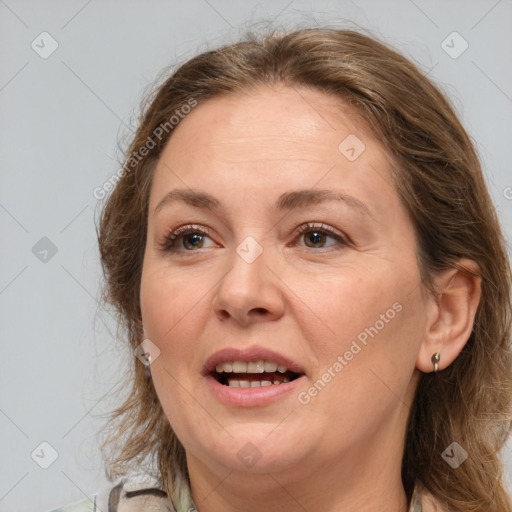 Joyful white adult female with medium  brown hair and grey eyes