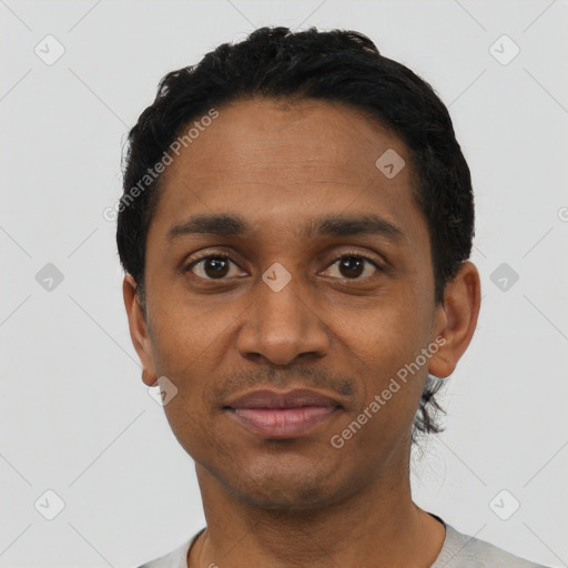 Joyful black young-adult male with short  black hair and brown eyes