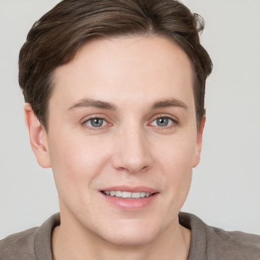 Joyful white young-adult female with short  brown hair and grey eyes