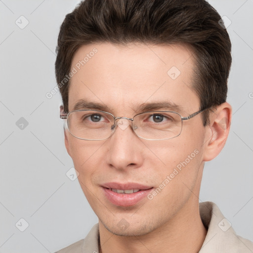 Joyful white adult male with short  brown hair and grey eyes