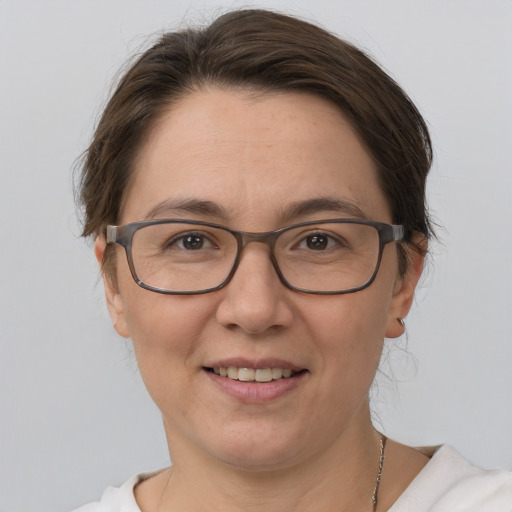 Joyful white adult female with medium  brown hair and brown eyes