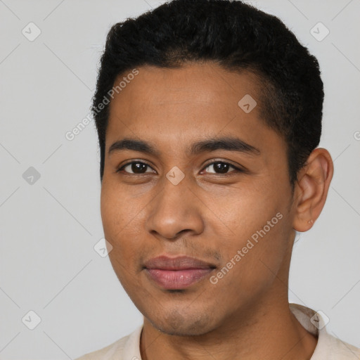 Joyful black young-adult male with short  black hair and brown eyes