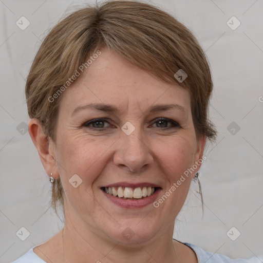 Joyful white adult female with medium  brown hair and grey eyes