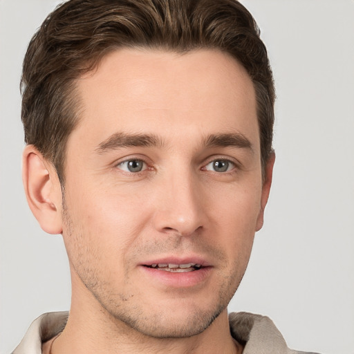 Joyful white young-adult male with short  brown hair and grey eyes