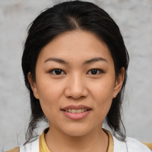 Joyful asian young-adult female with medium  black hair and brown eyes