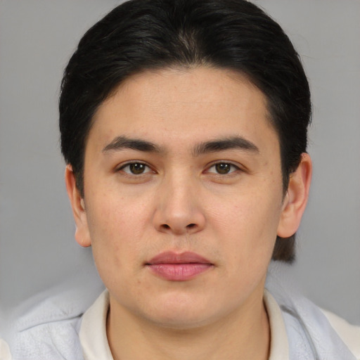 Joyful asian young-adult male with short  brown hair and brown eyes