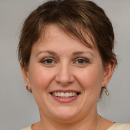 Joyful white adult female with medium  brown hair and brown eyes