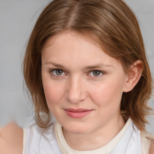 Joyful white young-adult female with medium  brown hair and blue eyes