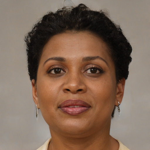 Joyful black adult female with short  brown hair and brown eyes