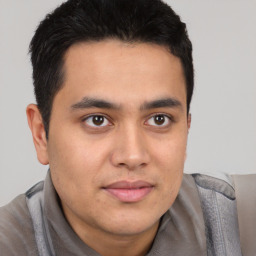 Joyful latino young-adult male with short  brown hair and brown eyes