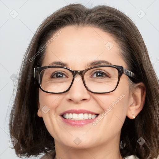 Joyful white adult female with medium  brown hair and blue eyes