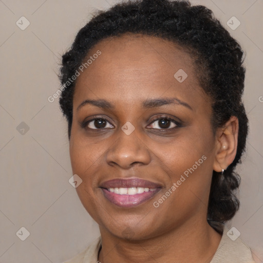 Joyful black adult female with medium  brown hair and brown eyes